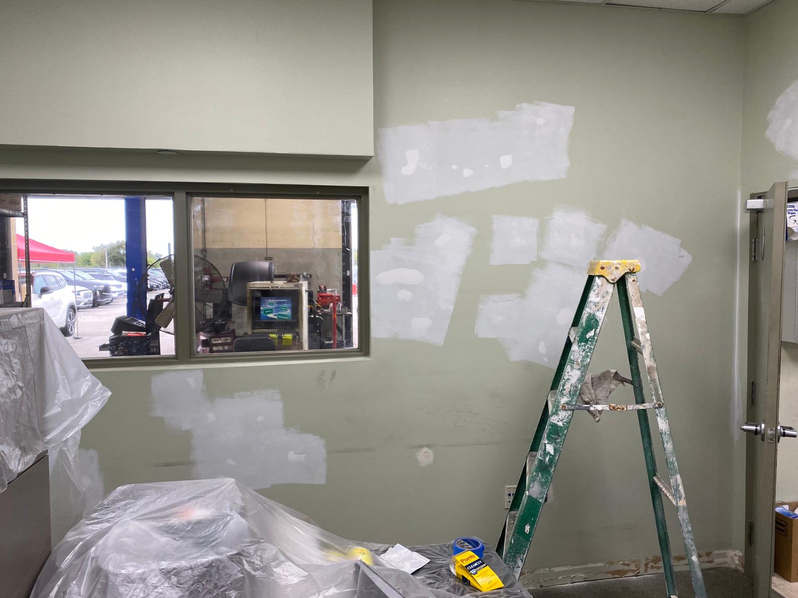 Interior wall prep with drywall patching and priming before repainting in a Miami commercial building