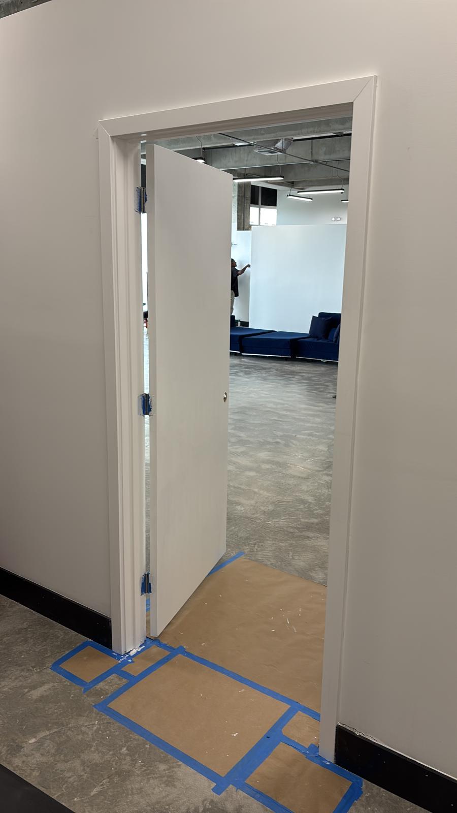 Interior door frame and trim painted white in a Weston commercial office renovation