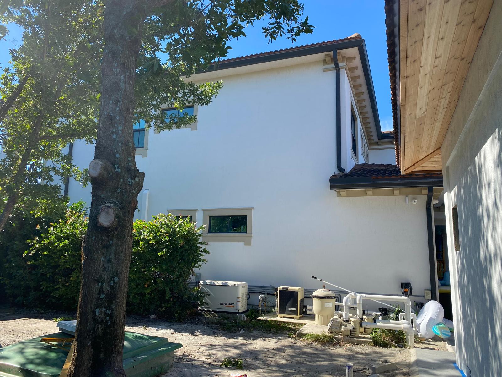 Freshly painted white stucco two-story residential home exterior with black trim in Weston Florida