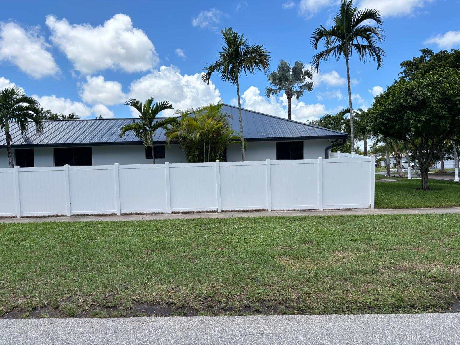 Long white vinyl privacy fence painting around a single-story residential home in Pembroke Pines Florida