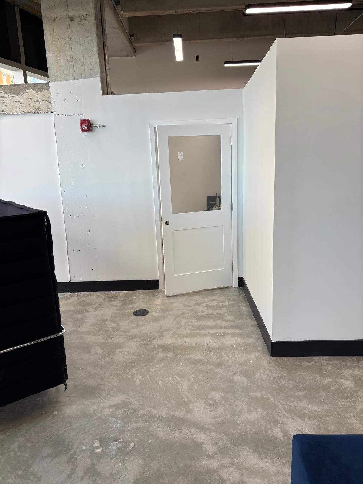 Freshly painted white commercial interior walls and door in a Coral Gables office space