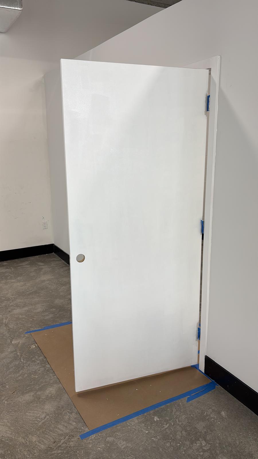 Freshly painted white interior door with smooth finish in a Delray Beach commercial project