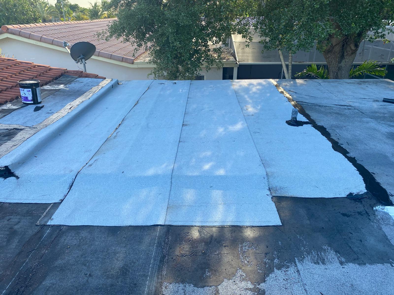 Freshly applied reflective white flat roof coating on a residential property in Boca Raton Florida